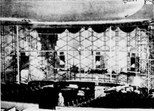 "SCREEN FILLS THEATER - Magical Cinerama will burst on this new circular 35-foot-high screen at premiere July 21.  Here technicians appear as pygmies making permanent installation at Villa Theatre." - , Utah