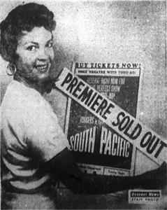 "PREMIERE SOLD OUT! - Patricia Owens Hollywood actress, pastes 'Sold Out' sign over poster for benefil premiere of 'South Pacific' Thursday." - , Utah