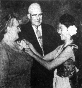 "ORCHIDS FROM PACIFIC - Receiving an orchid at the "South Pacific" premiere Thursday evening is Mrs. George D. Clyde, watched by Gov. Clyde. Early arrivers received orchids." - , Utah