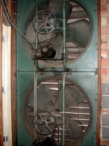 Two large fans are mounted in the wall, with a grill visible on the other side. - , Utah