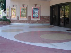 The entrance floor has a large white semi-circle with two larger light red circles and four smaller yellow circles. Four poster cases line a curved wall in the background. Entrance doors are on the right. - , Utah