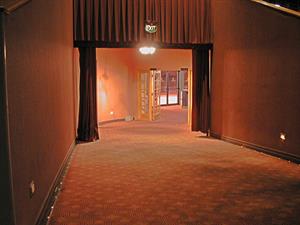 The north hallway from the auditorium looking towards the lobby.  A door behind the left curtain leads up to the projection room. - , Utah