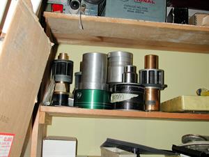 Projection lens sitting on a shelf, including one labeled "70mm." - , Utah