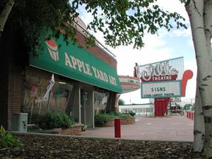 <span style='font-family: "Times New Roman"; font-size: small;'>The front of the Apple Yard store, with the sign of the Villa Theatre in the background.</span> - , Utah