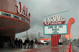 A dozen people stand in line at the box office. The word 'Villa' is visible above the entrance canopy on the left. The sign on the right reads, 'Lord of the Rings: The Two Towers.' - , Utah