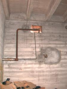 The south-west corner of the storage room.  A pipe exits through the coal chute opening. - , Utah