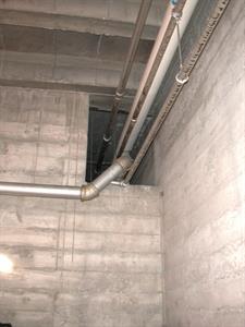The north-east corner of the storage room.  Pipes from the boiler room enter a tunnel. - , Utah