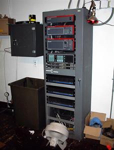 The sound rack on the back wall of the projection booth, with a fan on the floor providing cooling. - , Utah