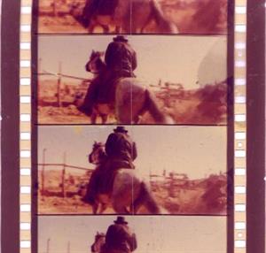 A close-up of two full frames of 70mm film, showing Indiana Jones from behind as he rides away on a horse. - , Utah