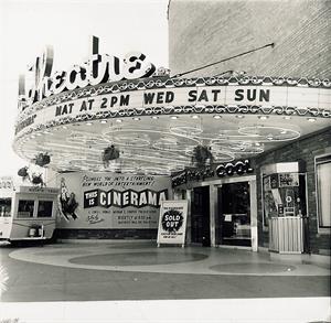 A view of the theater entrance, showing the original and elaborate neon underneath the circular canopy. A trailer is parked on the left. The entrance doors and ticket booth are on the right. - , Utah