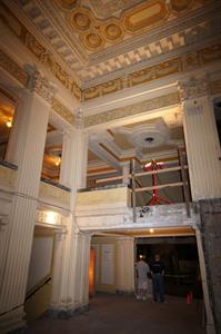 Two men look into the lower auditorium from the lobby.  The crate with the chandalier is to their left.   - , Utah