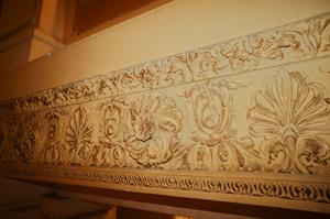 A close view of decorative scrollwork above an opening between the ramp and the lobby. - , Utah