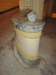A short section of railing extends out from a decorative column, then curves into a circular post at the end. - , Utah