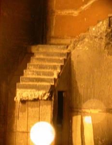 A blurry photo shows six concrete steps and a landing in the corner of the auditorium, with the lower portion of the stairs removed. Underneath the remaining stairs, on the side, is an open doorway. - , Utah