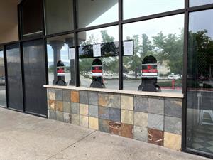 The ticket booth windows reflect the parking lot across from street. - , Utah