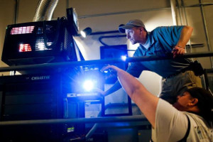 Theater employees test a Christie digital projector. - , Utah