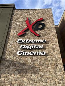 A close shot of the XD logo on a wall of cut stone. The logo features a red, hand-written letter X with a smaller capital letter D in black. - , Utah