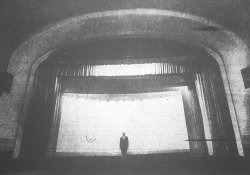 August D. Nardoni of Sero Amusement Co. stands on the stage of the Lyric Theatre in 1971, when the theater stopped showing movies.  The screen is probably the same size and shape as the CinemaScope screen installed in 1953.