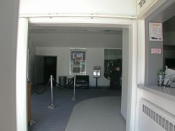 Looking through the entrance of the theater.  The current ticket booth is on the right.  A old projector is on display in the lobby.