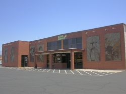 The entrance of the theater is in the center of the building, with two murals on either side.  A third auditorium appears to have been added on the side of the original building.
