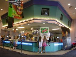The concession stand of the theater features a dropped ceiling lined with television monitors.