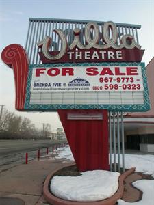 A banner hangs on the sign's attraction board. Snow covers the planter box around the sign. - , Utah