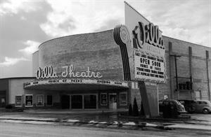 A black and white photograph of the Villa Theatre from across the street. Three vintage cars are parked on the side of the building. An employee stands in the ticket booth. - , Utah