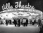 Moviegoers stand beneath the circular marquee at night. - , Utah