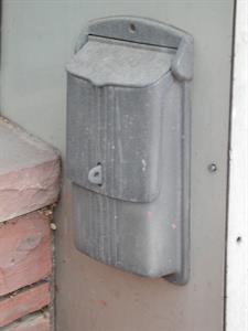 A mailbox on the side of the store entrance. - , Utah