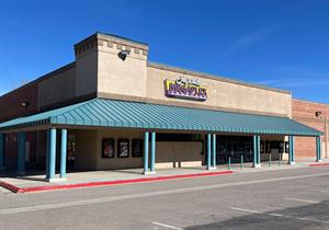 A light green canopy supported by eight pairs of pillars covers three pairs of doors on the front and one pair on the left wall.  The Megaplex Theatres logo is mounted above the canopy on the front wall, with some touch up in the stucco where the 'Stadium 8' logo was removed. - , Utah
