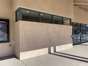 On the left of the theater's entrance doors, a section of the wall juts out about three feet.  Above where the box office used to be, a row of four rectangular windows remain. - , Utah