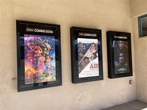 Three poster cases mounted on an exterior wall.  On the right, a wall sticks out where the former box office used to be. - , Utah