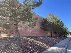 Trees line the northeast wall of the theater on a short hill descending to the sidewalk along Bentley Boulevard.   - , Utah