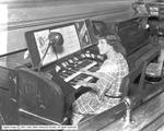 Miss McIntyre at the organ console in the orchestra pit. - , Utah