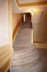 Three wide quarter-circle steps lead to a landing.  A staircase leads up from there to the balcony. - , Utah