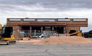 Construction fencing and equipment occupies an area of the parking lot in front of the Red Cliffs Cinema in 2022.