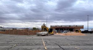 Looking across the parking lot with the theater in the background on the right. Temporary fencing surrounds large piles of earth. - , Utah