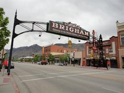 An arch welcoming visitors to Brigham City spans Main Street, obscuring the front of the Capitol Theatre from the south. - , Utah