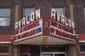 Above the entrance of the Avalon hangs a traditional triangular marquee, with a two-line attraction board.