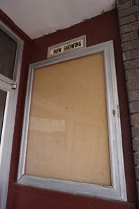 An empty 'Now Showing' poster case on the right side of the entrance doors. - , Utah