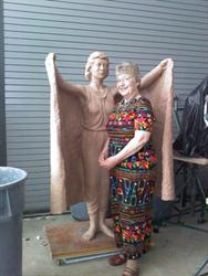 Casino Star Theatre Foundation Director Diana Spencer stands next to an angel sculpture by Sculptor Brad Taggart in a studio at Snow College. - , Utah