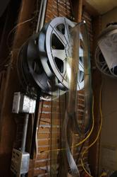 Reels and lengths of film hang from the wall by the workbench. - , Utah