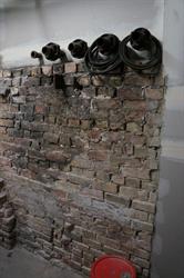 An original brick wall remains in the new furnace room. - , Utah