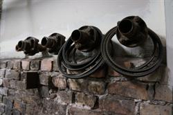 Belts hang from the old pipes leading to the radiators. - , Utah