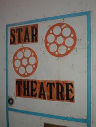 The words, 'Star Theatre' and a copy of film reels adorn the side wall of the theater entrance. - , Utah