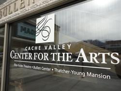 The logo and name for the "Cache Valley Center for the Arts" appears on of the windows along the front of the theater. - , Utah