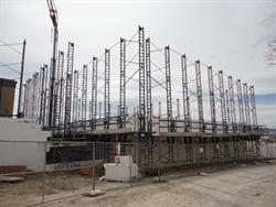 Scaffolding surrounds a new auditorium as its walls begin to rise. - , Utah