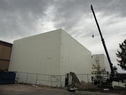 A crane stands by a new auditorium on the north side of the existing building. - , Utah