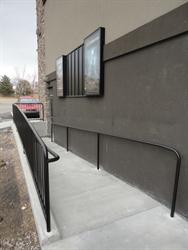 A wheel-chair accessible ramp down to an auditorium exit door. - , Utah