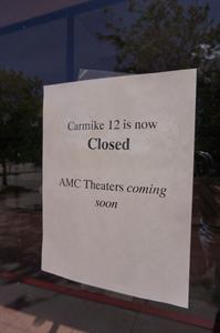 A paper taped to the glass at the entrance says, "Carmike 12 is now Closed.  AMC Theaters coming soon."
